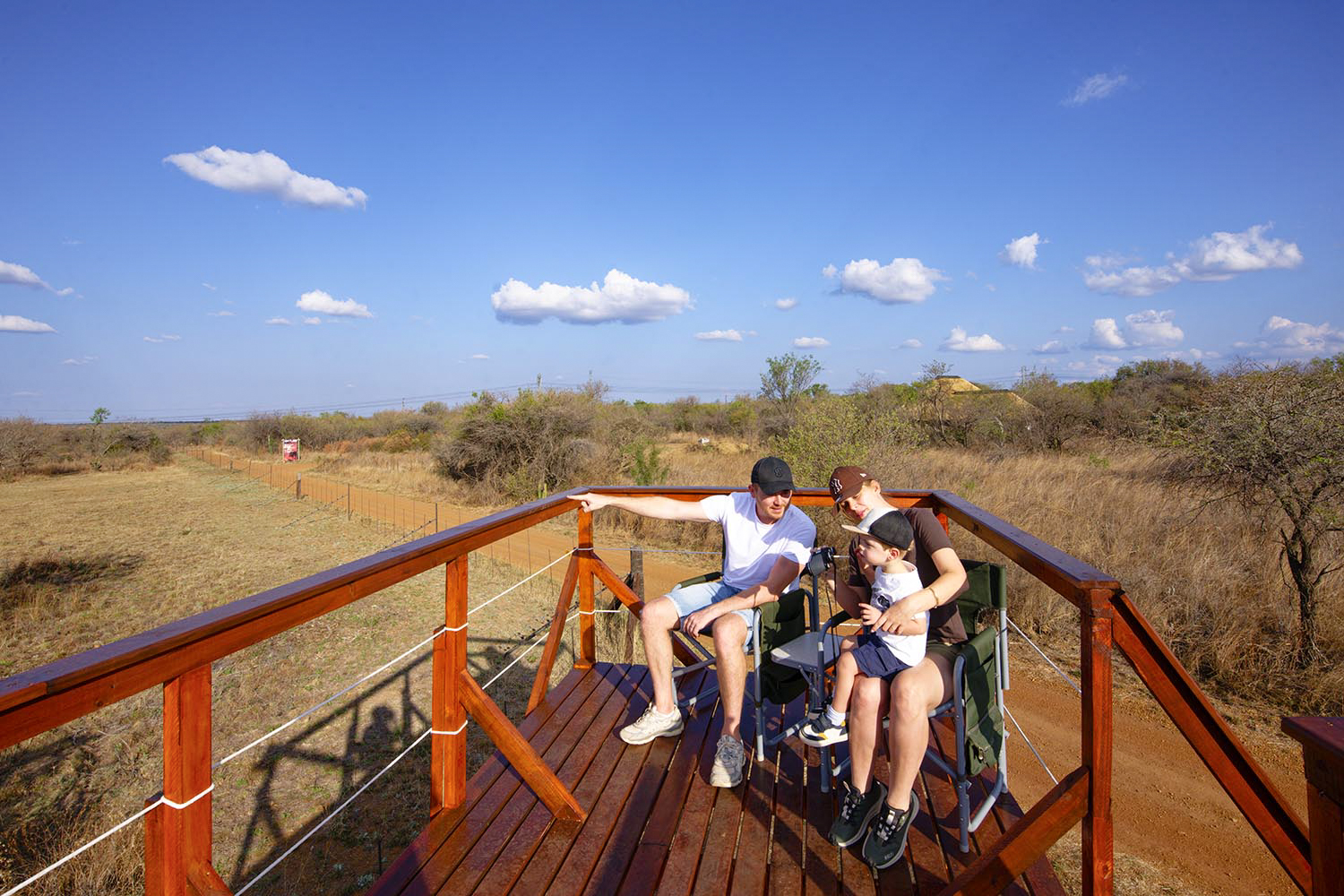A family seated together while watching the bush